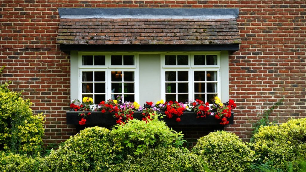 beautiful spring flowers outside a brick home