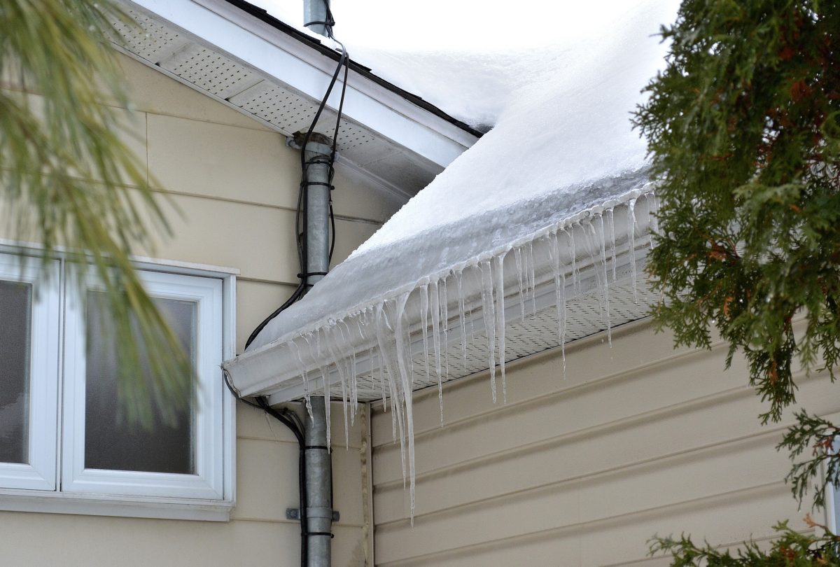 This shot shows ice, overflowing a gutter, causing Ice Damming