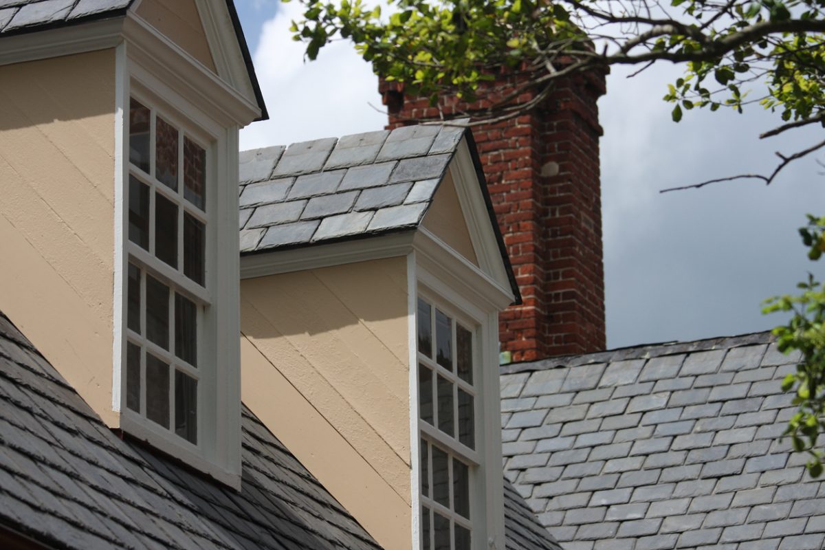 Windows of a home with slate tile roofing