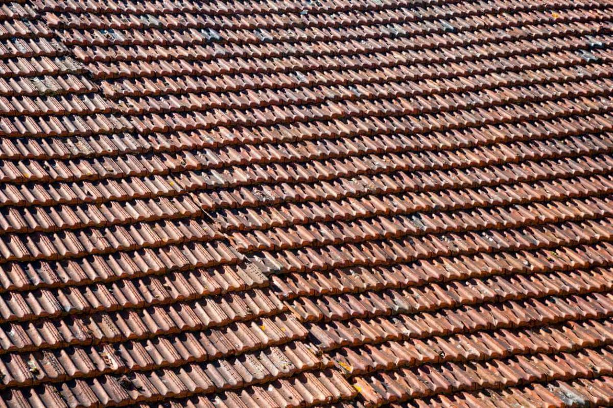 A large expanse of rustic French roof tiles, full frame construction background texture