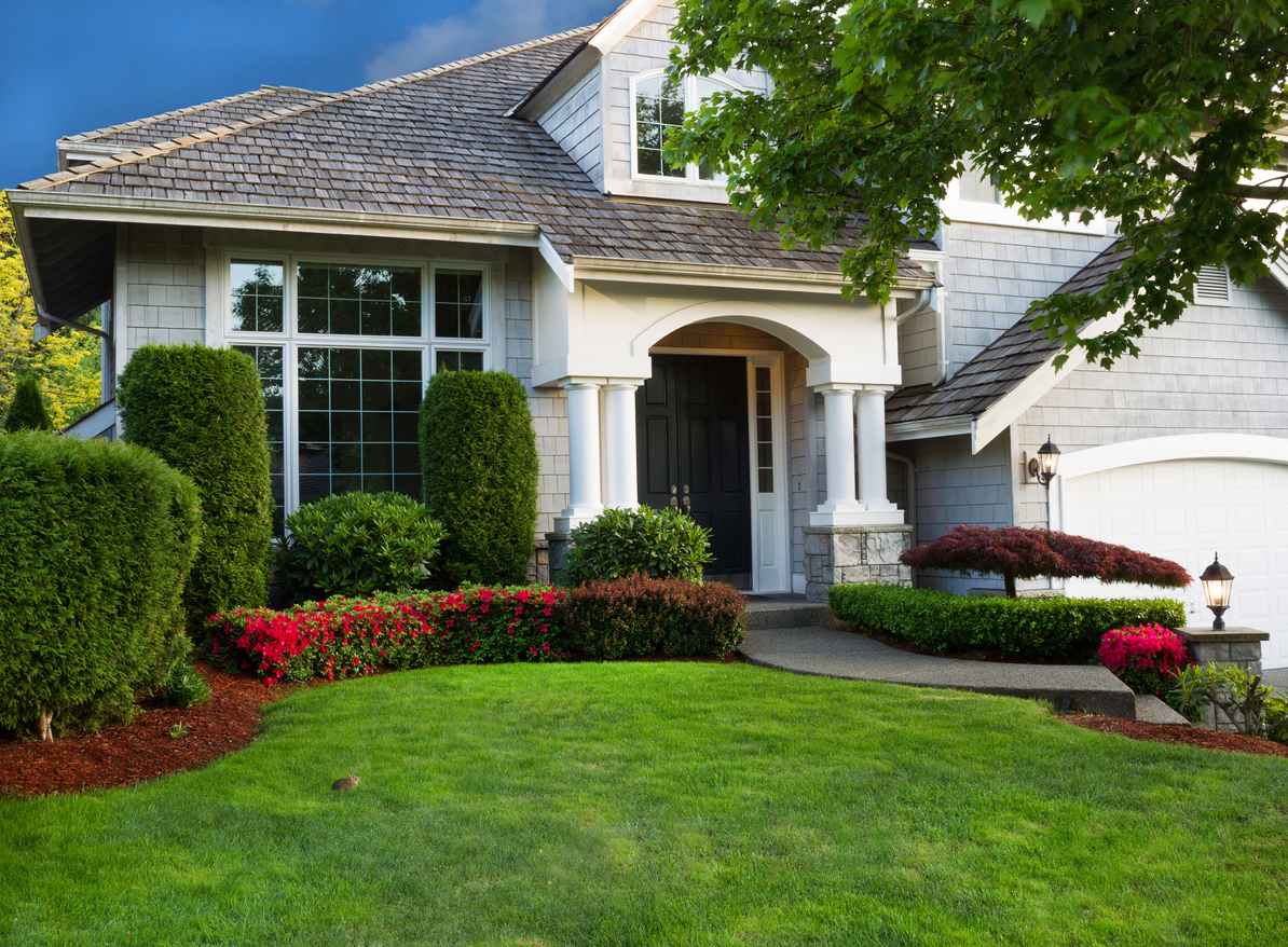 Clean exterior and landscape of residential home, spring-proofing tips for your home's roof