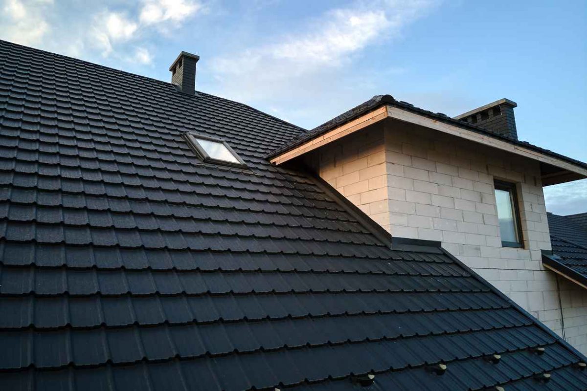 Closeup of house roof top covered with ceramic shingles.